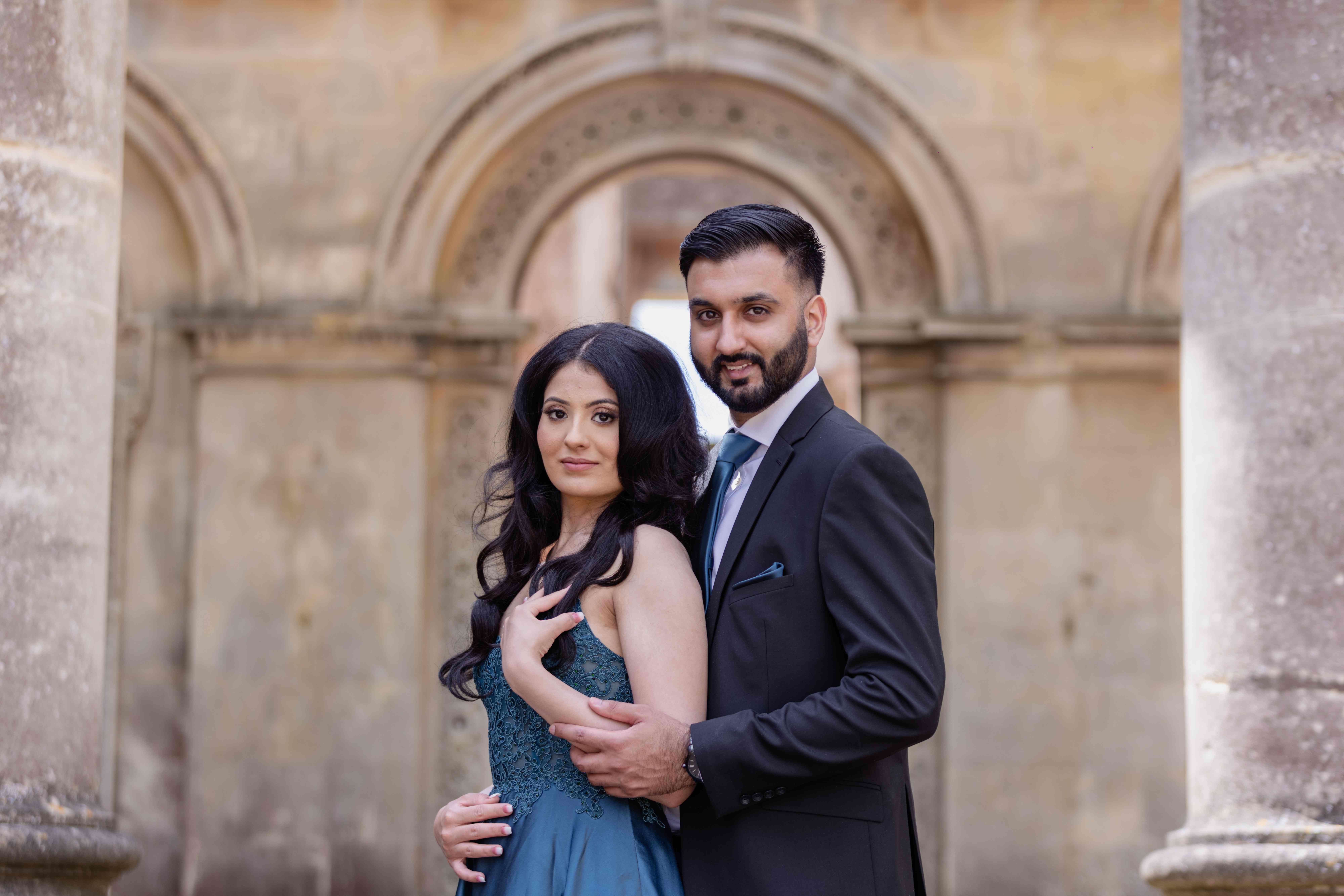 Couple portrait with stone archway backdrop