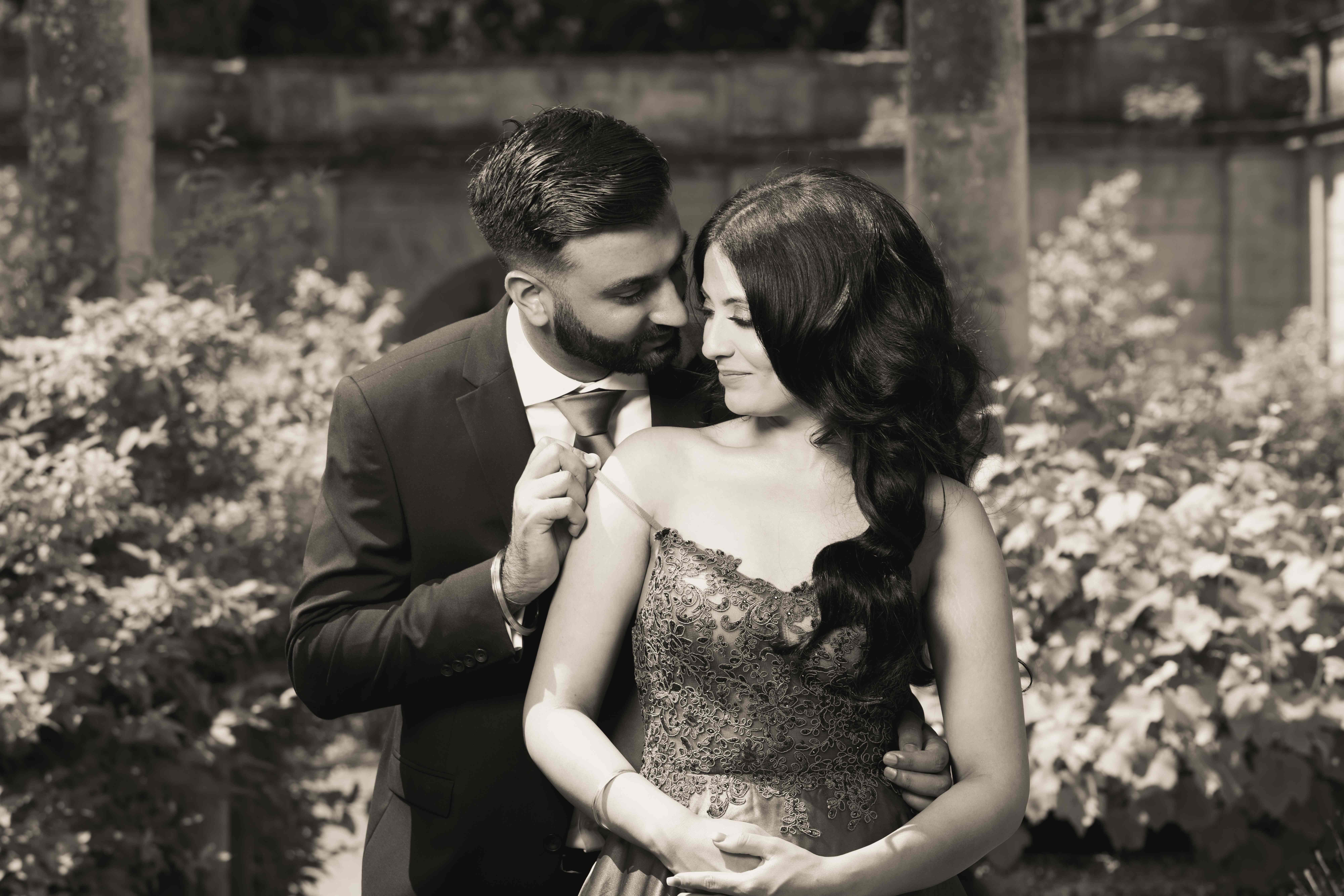 Romantic sepia-toned couple portrait in garden setting